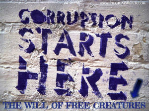 Corruption Starts Here - the will of free creatures - white paint peeling on brick wall - blue words