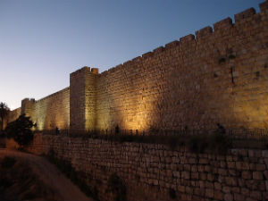 Barbarians at the Gate: Where do We Turn? Weekly Blog Post by Dr. Craig Biehl - stone wall of Jerusalem lite up