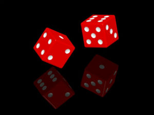 Random Chance Behind an Ordered Universe? - Weekly Blog Post by Dr. Craig Biehl - Red dice with reflection on black